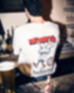 man wearing henny's brand t-shirt while making cocktails