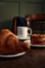 close up of a coffee and pastry on a coffee table