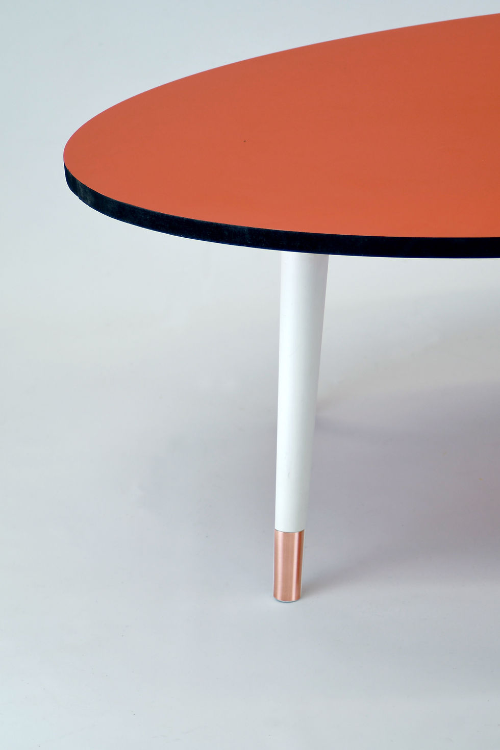 Thumbnail: Oval Orange top coffee table with black edge,tapered legs and stainless steel fe