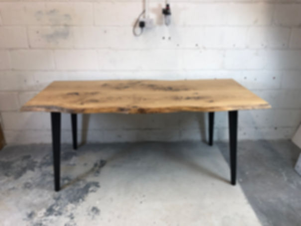 Live edge solid oak dining table with 2 wooden slabs and 4 wooden angled tapered