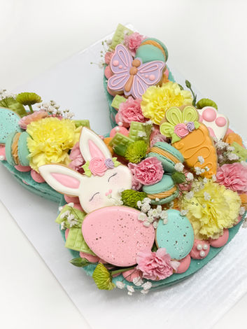 Bunny Tart Cake covered with beautiful florals, sugar cookies, french macarons and sprinkles.