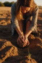 Leonardo_Kino_XL_A_real_woman_is_sitting_barefoot_on_warm_eart_0.jpg
