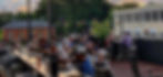 People enjoy dining outdoors on a terrace at sunset at Nellies Southern Kitchen