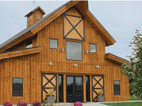 Rustic event venue at Camelot Meadows set among grassy fields and rural landscape