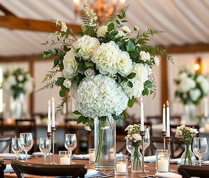 Wedding Reception Farmhouse table with tall white and greenery whimsical flower arrangemen