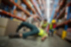 Workers taking care about their colleague lying on the floor in a warehouse.jpg