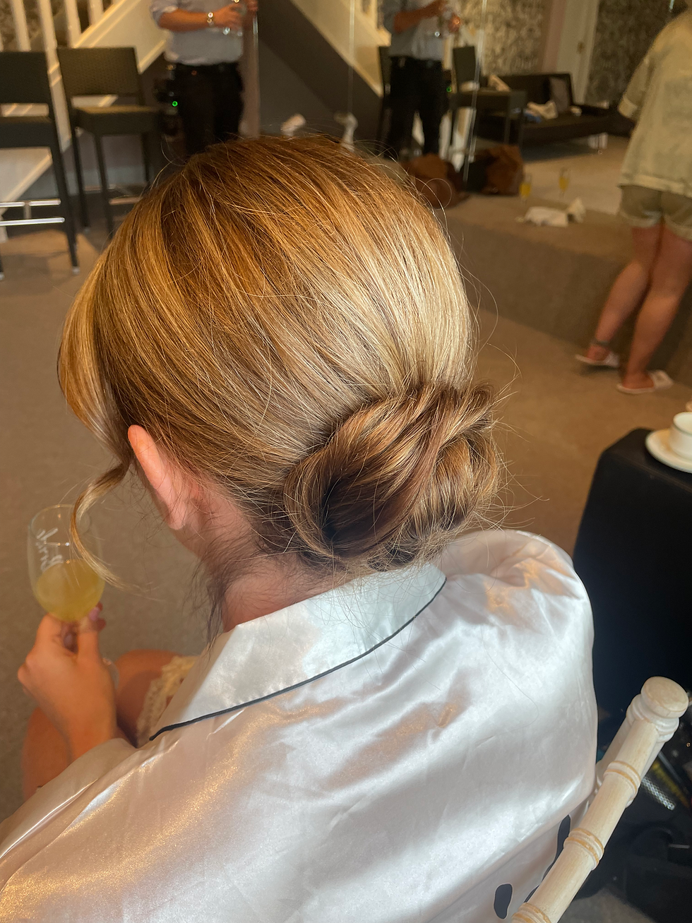 Chic bridal hairstyle featuring a sleek low bun—ideal for elegant weddings at luxurious Lancashire venues like Eaves Hall.