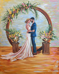 A 16x20 live wedding painting by Ariel Quiroz, capturing a couple's romantic embrace under a floral arch in Lahaina. The bride, in a white fitted gown with a trailing veil, and the groom, in a sharp blue suit, stand forehead-to-forehead, exuding intimacy and affection. Tropical flowers and foliage adorn the wooden arch and matching planters on either side, highlighting the natural beauty of Maui as the setting sun casts a warm glow over the scene, encapsulating the couple's joy on their special day.