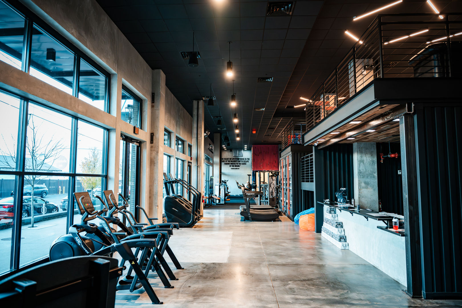 Open-concept fitness facility with premium training equipment, custom lighting, and contemporary finishes.