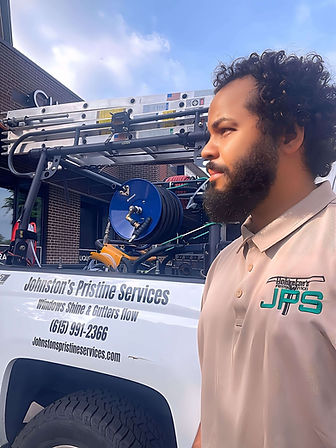 Hasan Johnston standing beside Johnston’s Pristine Services work truck, ready for residential window cleaning in Nashville TN