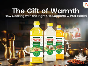 Nuova cold-pressed groundnut, coconut, and flaxseed oils arranged as a thoughtful winter gift in a warm kitchen setting with traditional utensils, highlighting healthy cooking oils for winter wellness and festive nourishment.