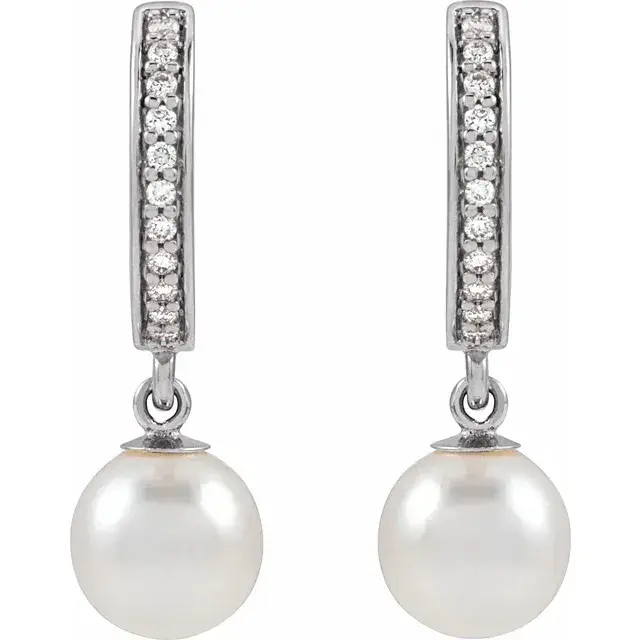 Pearl and diamond dangle hoop earrings.