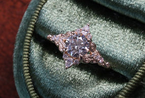 Round lab grown diamond filigree antique style engagement ring with small accent diamonds, set in yellow gold.