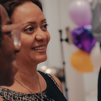 A smiling woman listening to the activity instructions
