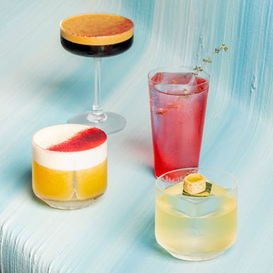 A selection of curated cocktail drinks on Analogue Initiative's 3d printed bar top 