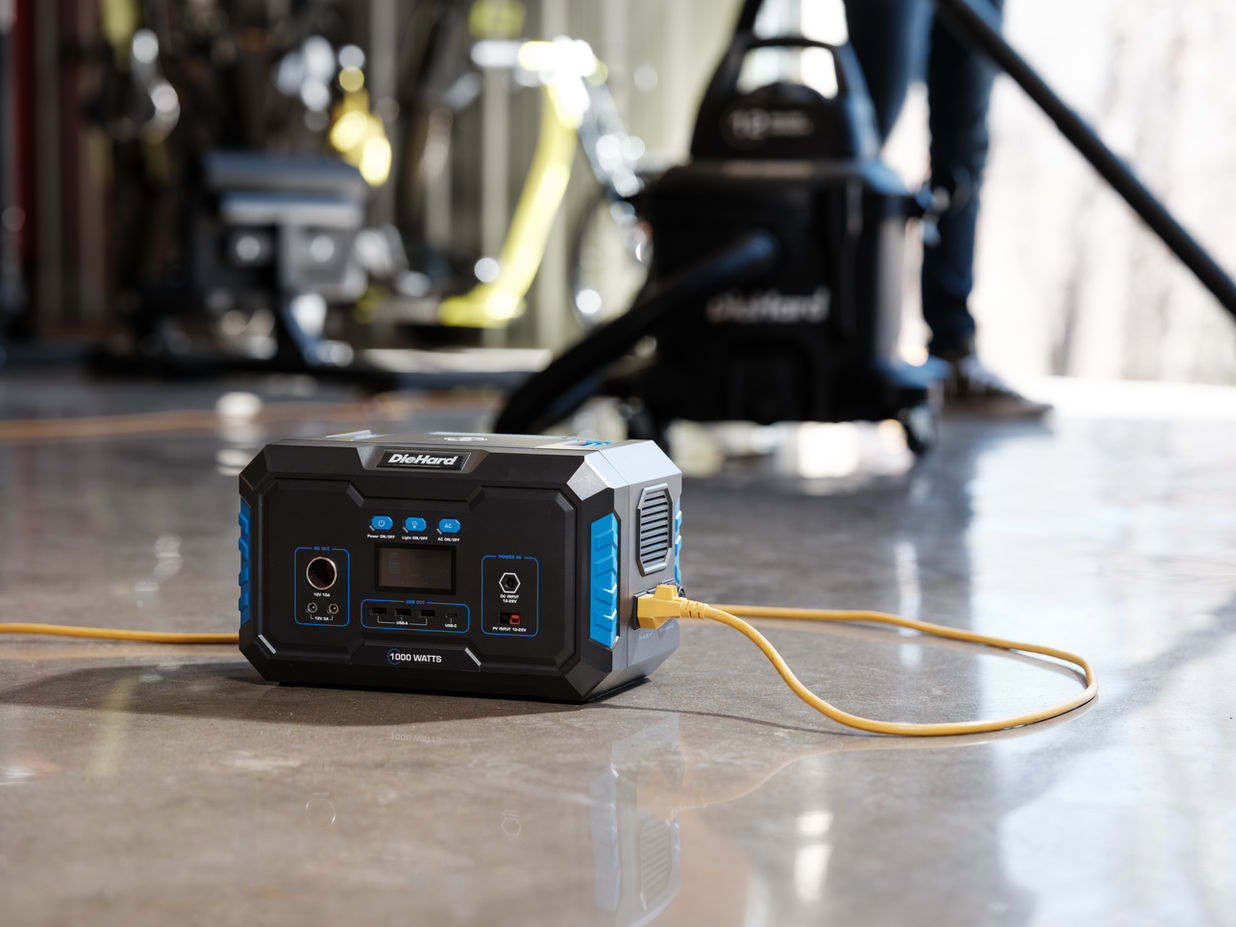 DieHard 1000W Portable Power Station in a garage powering a Wet Dry Vacum