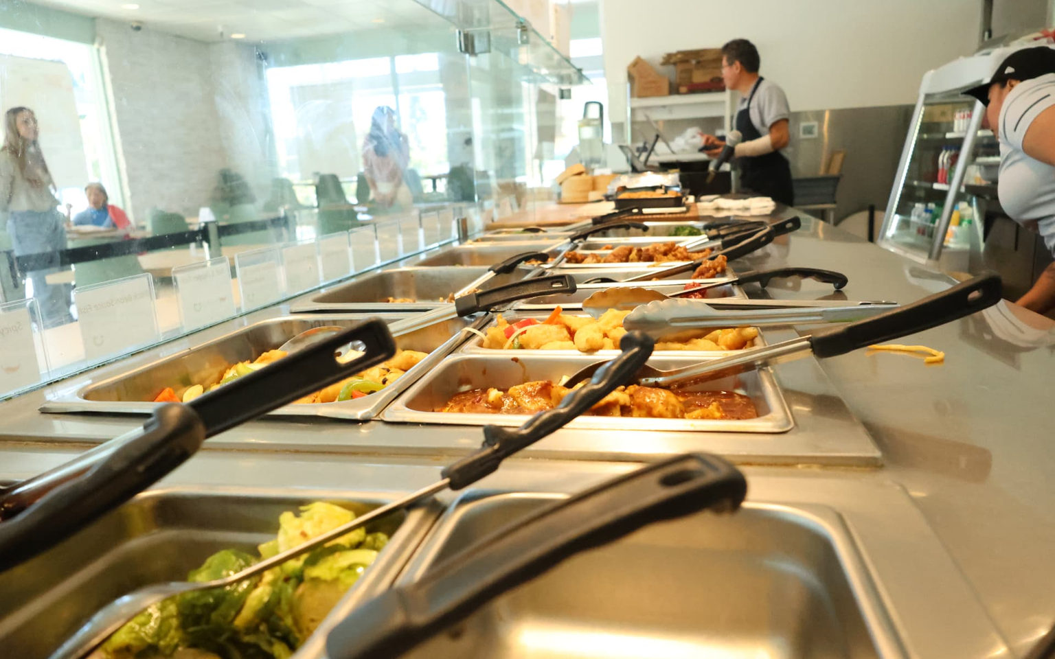 The Eaping hot bar with pans of food during service