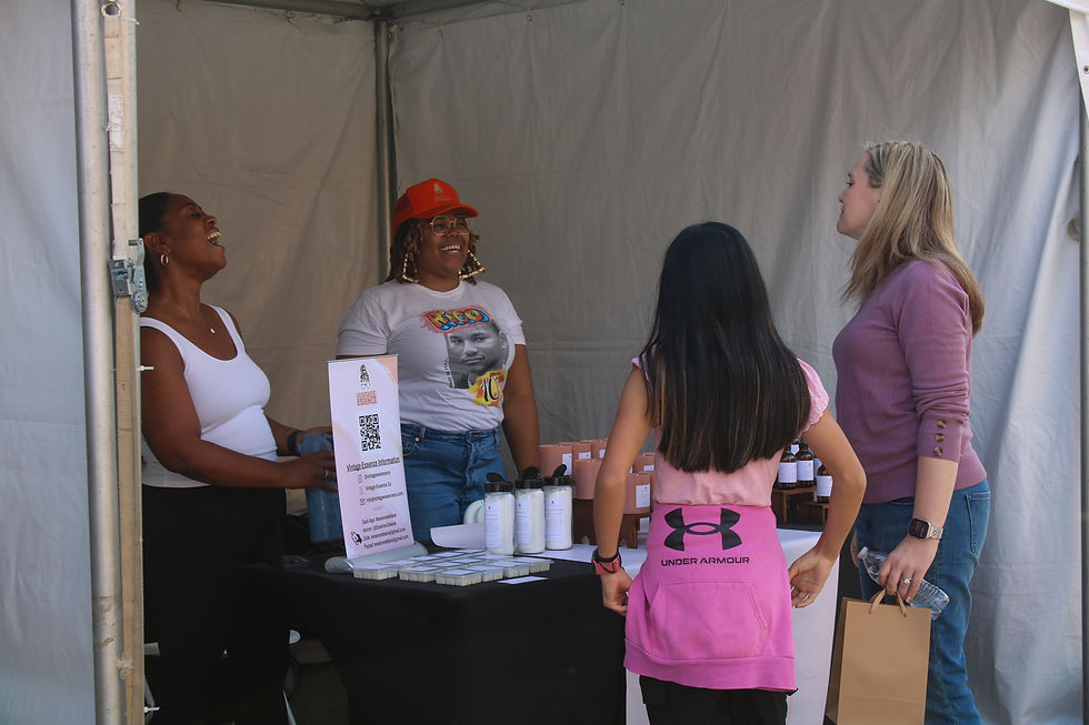 Business owner Essence Collins talks to customers at her Vintage Essences booth. (Kate Basler)