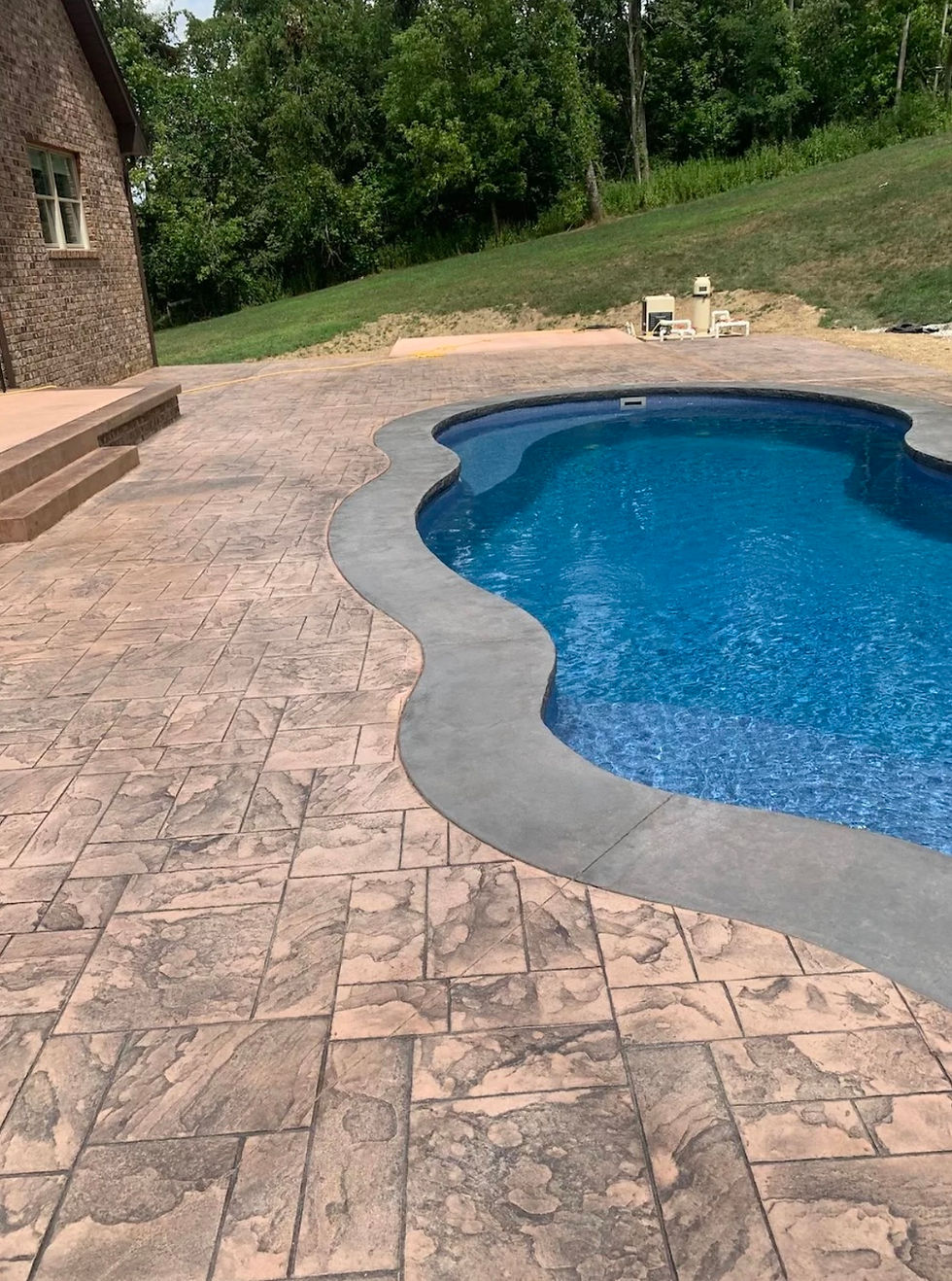 Professional concrete grading work showing proper slope installation for Pittsburgh home drainage protection