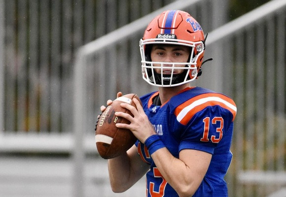 Coast Guard Bears quarterback Joe Armentrout, wearing #13, prepares to pass the football.