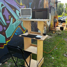 outside standing desk with computers and equipment