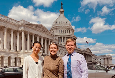 Three people standing in front of the Capitol Building