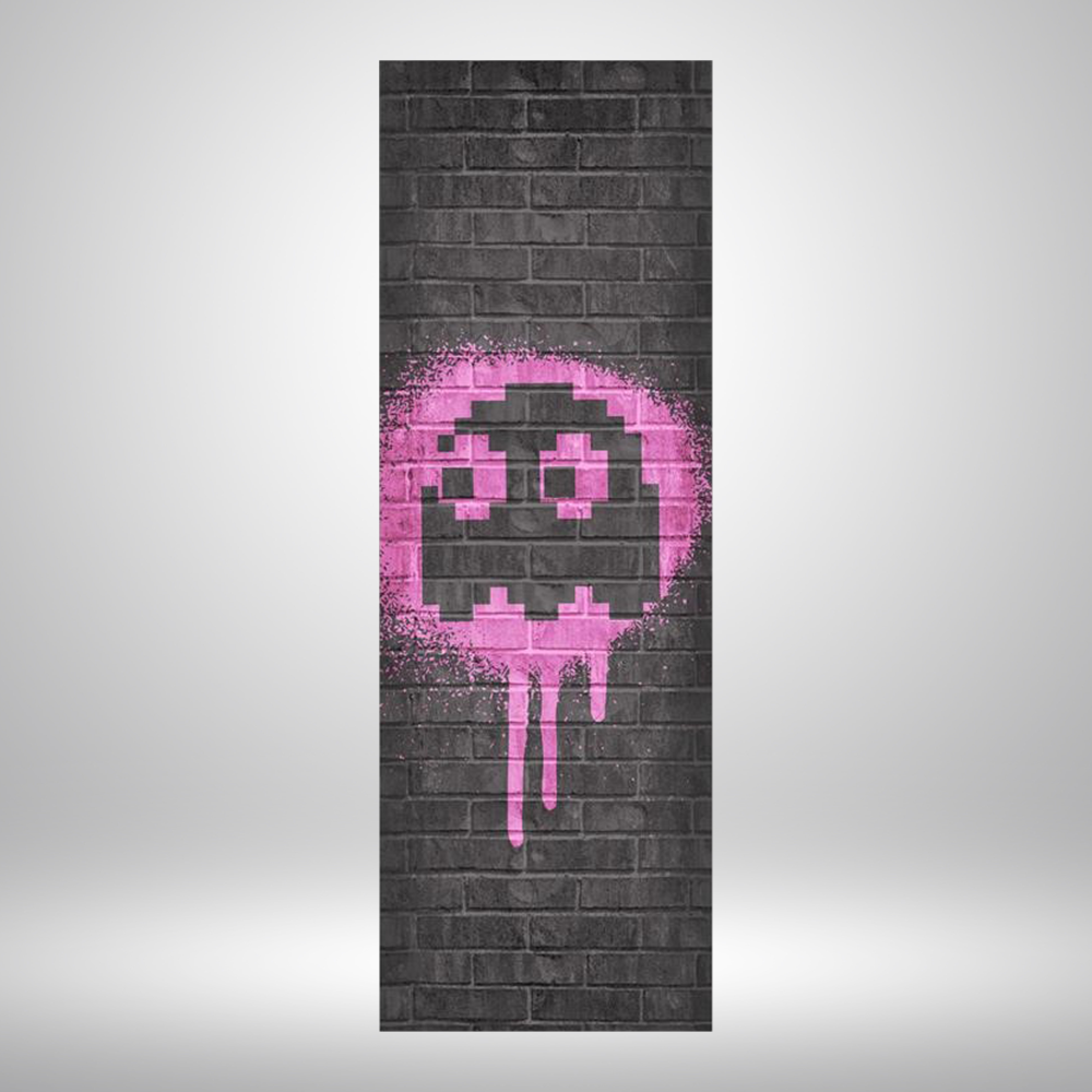 Skinny tapestry with black brick background and pink Pac-Man ghost spray painted graphic