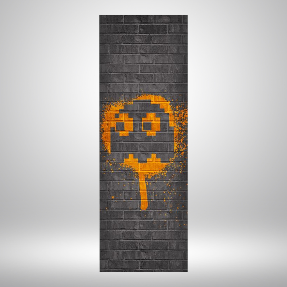 Skinny tapestry with black brick background and orange Pac-Man ghost spray painted graphic