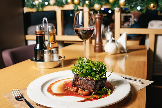 beef-steak-with-arugula-champignons-white-plate-table-restaurant.jpg