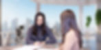 2 women sitting at a desk working
