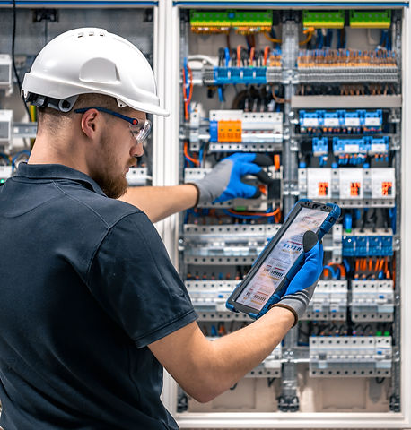 electrical-technician-working-switchboard-with-fuses-uses-tablet_edited.jpg