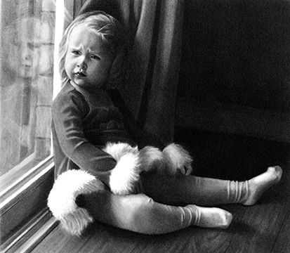 Little girl sitting by a window and holding a stuffed animal