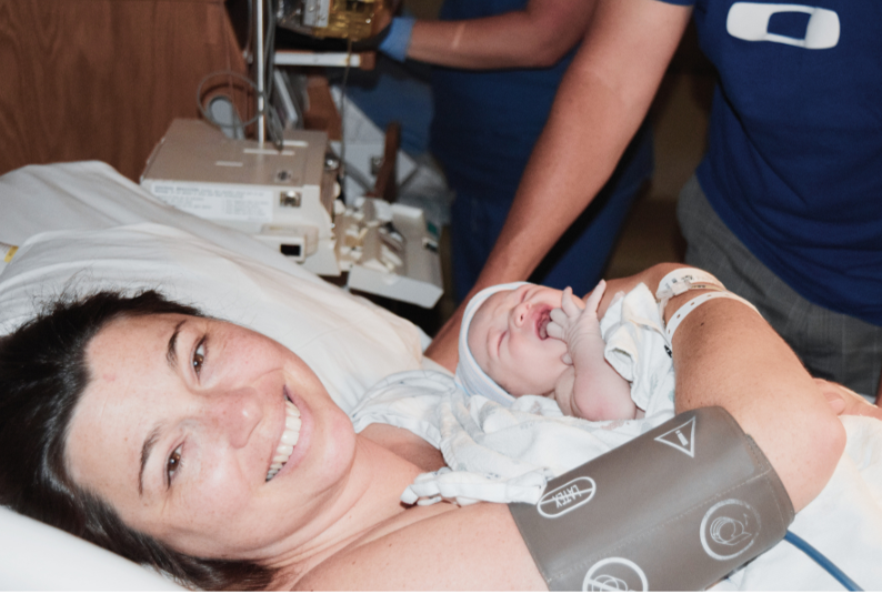 Mother in hospital bed with newborn just after birth