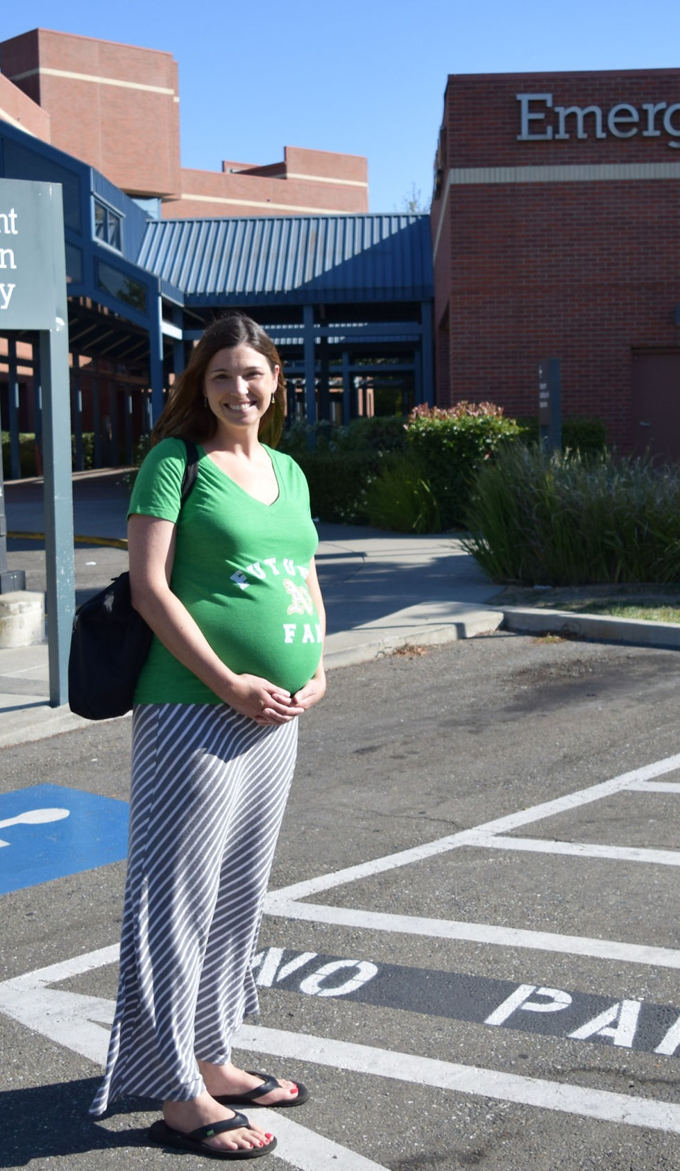 pregnant women standing in front of hospital