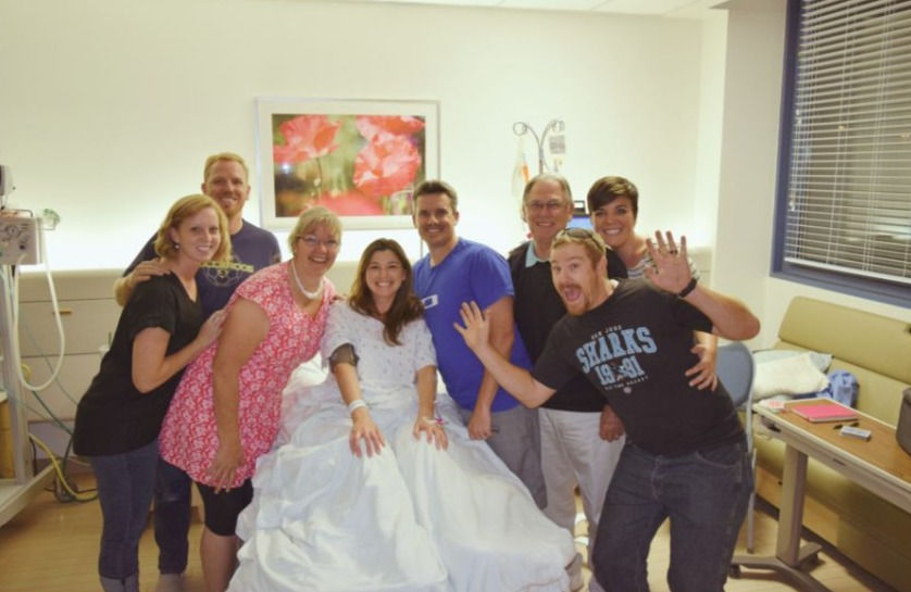 Family with pregnant woman in bed