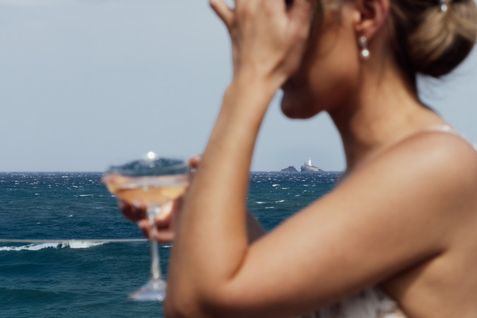 The sea can be seen behind the bride on her wedding day.