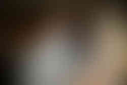 Bride and groom sharing their first dance surrounded by friends and family