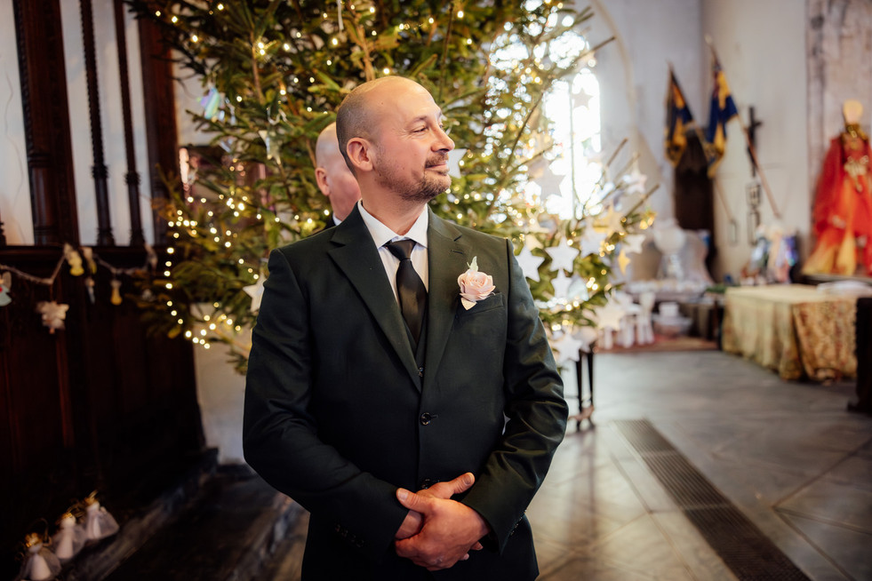 The groom waits anxiously for the bride to walk down the aisle