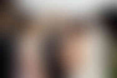 A wedding guest laughs with the bride 