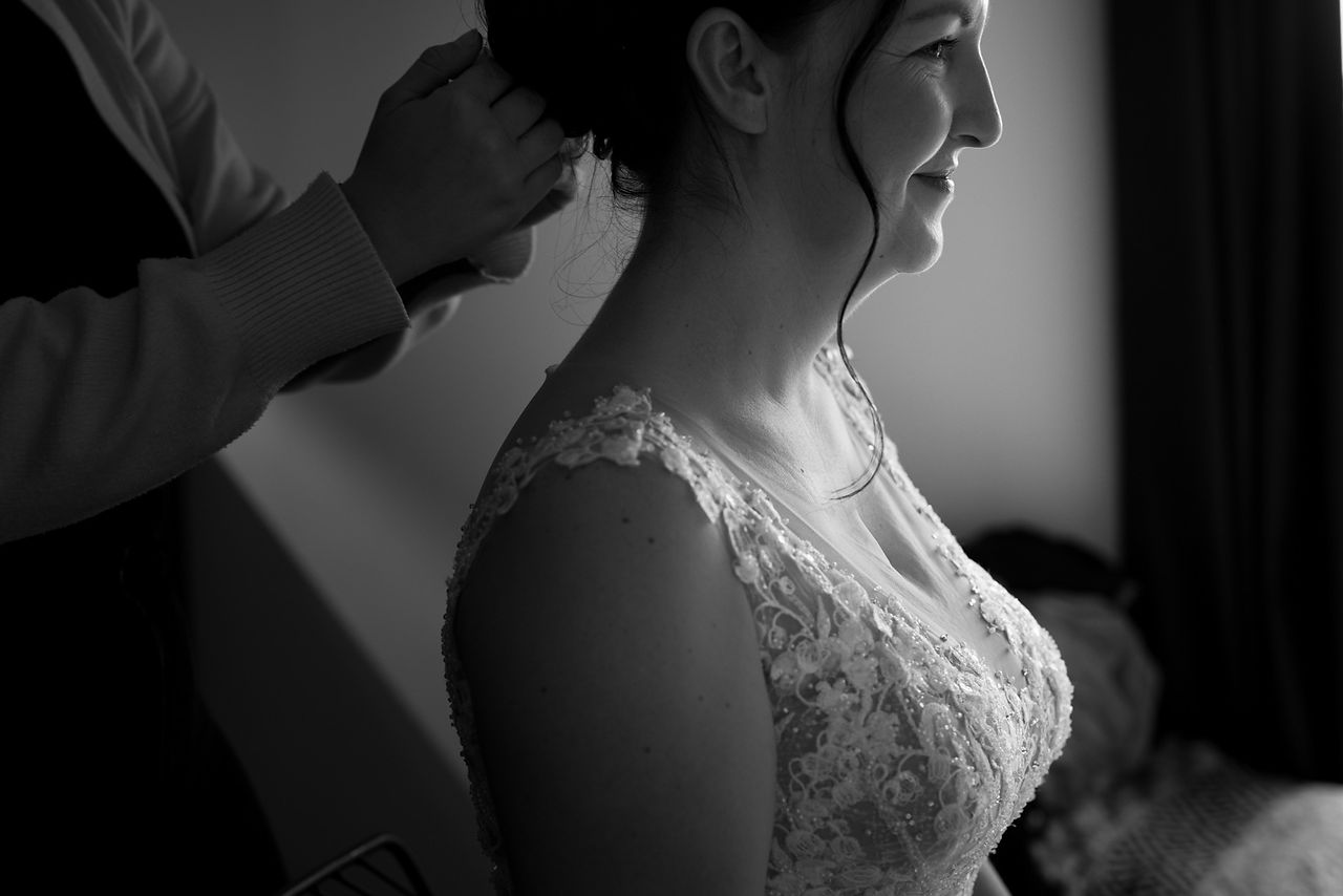 A bride has her veil put in