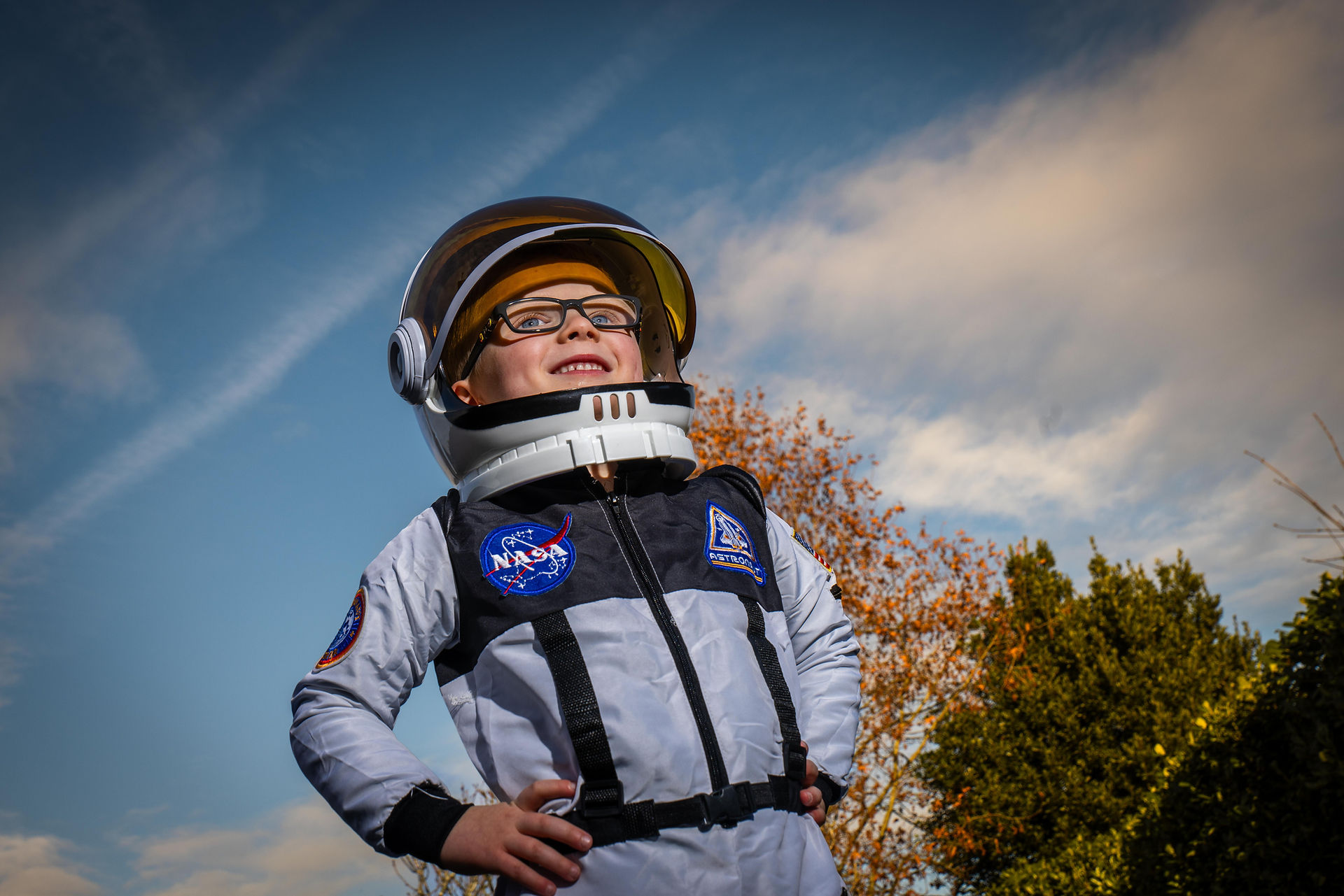 A child stands in an astronaut costume. Captured by Jake McPherson for SWNS