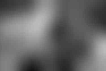 A guest laughs and points at another guest during the wedding reception