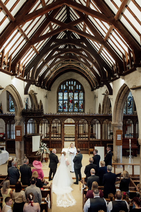 A wedding ceremony in a grand church takes place in Devon.