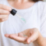 Female using dropper to add Cleansing Oil With Wild Manuka & Blue Tansy Oil to palm