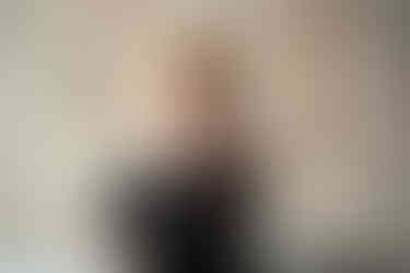 Des Moines, Iowa and Norwalk Iowa family photography - toddler boy with curly blonde hair holds out red rose petals.