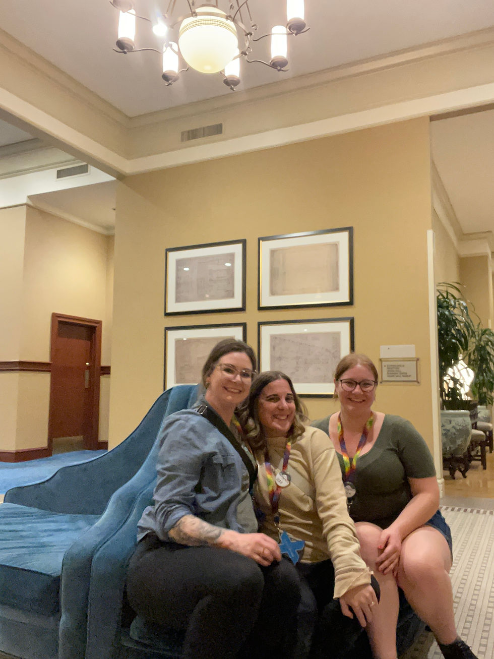 Des Moines, Iowa portrait photographer - three adult woman posed on a blue couch smiling.