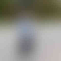 Des Moines, Iowa event photographer - a woman wearing black leggings and a white vest eats a banana after the race