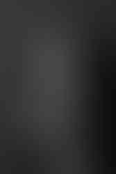 Des Moines, Iowa Headshot and Branding photography - Black and white image of a woman wearing a high contrast geometric patterned blazer smiles with her arms crossed.