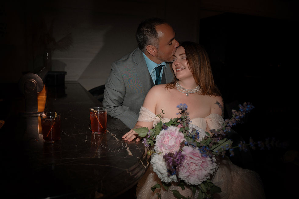 Norwalk and Des Moines Iowa couples photographer - man in suit kisses woman in dress on the forehead