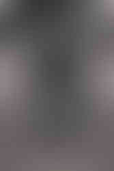 Norwalk and Des Moines, Iowa family photographer - black and white image of adult siblings lying in the grass stacked on top of one another in an awkward photoshoot position.